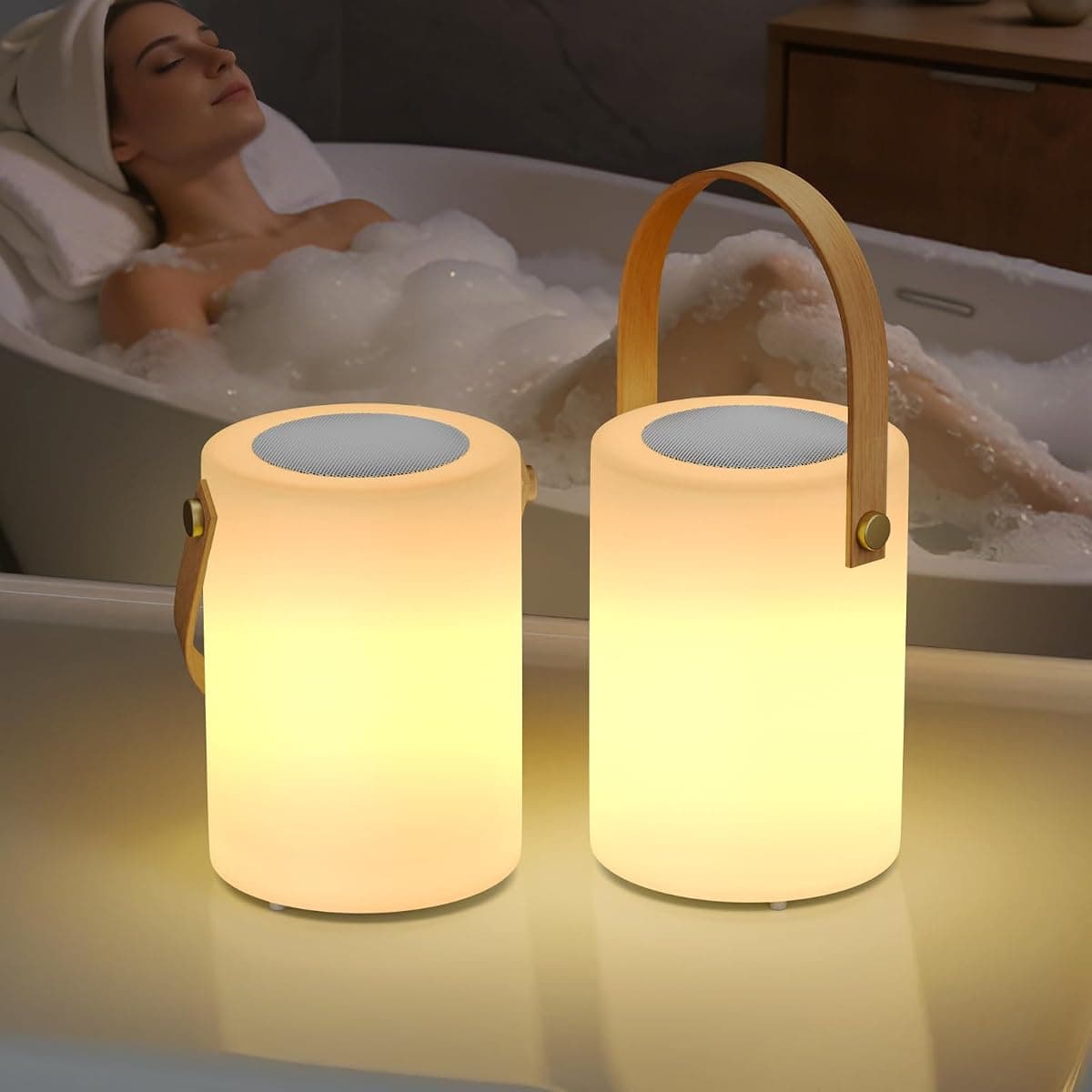 Two small warm-white lanterns with leather carry handles